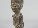 an image of a wooden cup shaped like a man holding a baby