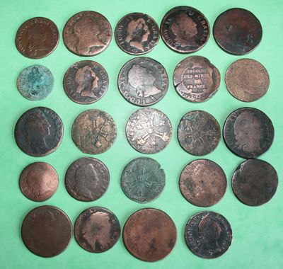 a bunch of coins sitting on top of a green surface