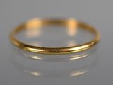 a close up of a gold ring on a white surface