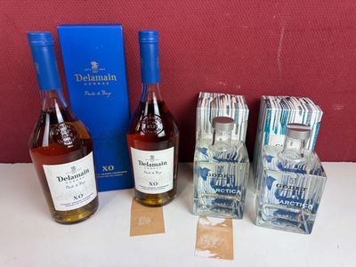 plusieurs bouteilles d'alcool posées sur une table, à côté d'une boîte bleue