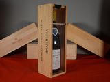 a bottle of wine in a wooden box on a table