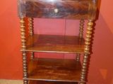 a wooden shelf with a drawer on top of it
