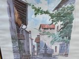 aquarelle encadrée représentant une scène de rue avec des bâtiments et des arbres