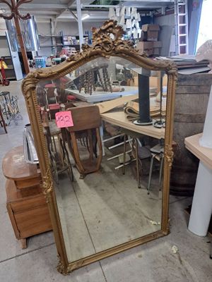 a large mirror sitting on the floor in a store