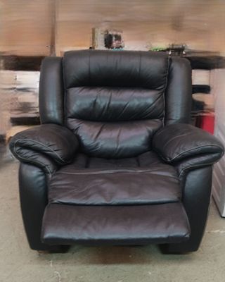 un fauteuil inclinable noir qui se trouve dans une pièce