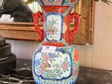 a vase with flowers in it sitting on a table