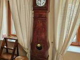 a grandfather clock in the corner of the room
