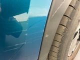 a close up of a car ' s front door with a broken window