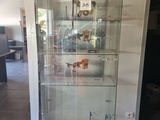 a glass display case in the middle of a room