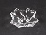 clear glass bowl on a black table with a black background