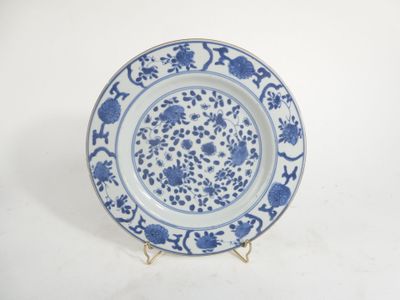 a blue and white plate with a floral design on it