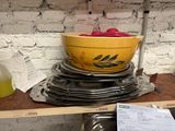 a yellow bowl on top of a stack of plates
