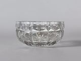two clear glass bowls sitting next to each other on a table