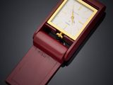 an image of a red watch with a gold face