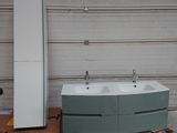 two sinks and a refrigerator in a garage