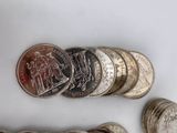 a lot of coins sitting on a table next to each other