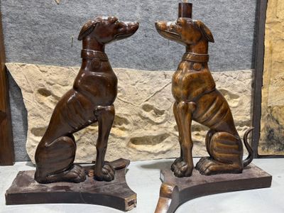two statues of a dog and a cat sitting on a table