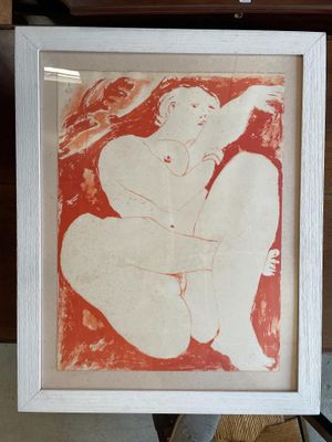 une photo d'un tableau représentant une femme nue, dans un cadre blanc