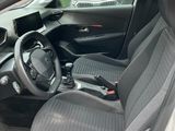 the interior of a small car with two seats and a steering wheel