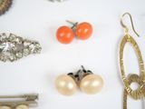many different types of jewelry on a white surface