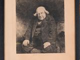 an old black and white photo of a man sitting in a chair