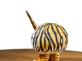 a tiger figurine on a table with a white background