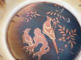 two birds sitting on a tree branch painted on a vase