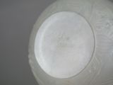 a white vase with writing on it sitting on a table