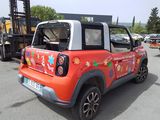 a small red car with flowers painted on it