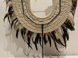 an image of a white and black purse with feathers on it