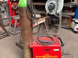a red machine that is sitting in the garage