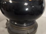 a black vase with a gold design on it