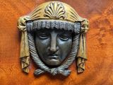 a wooden cabinet with a metal face on it