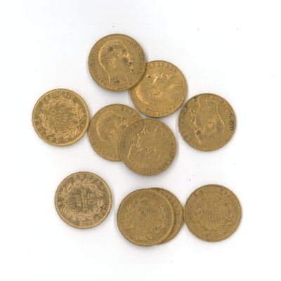 quelques pièces d'or posées sur une surface blanche, sur fond blanc