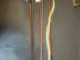 three wooden canes and a pair of scissors on a table