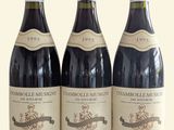 three bottles of wine sitting on top of a table next to each other