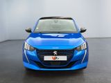 the front view of a blue car in a white room