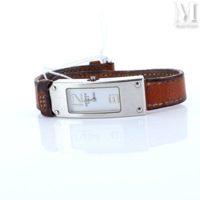 a brown leather bracelet with a silver plate on it