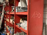 a red shelf filled with assorted items in a garage