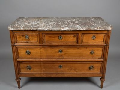 an antique chest of drawers with a marble top