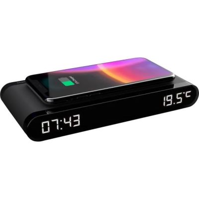 an image of a black alarm clock with a phone on it
