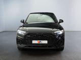 the front end of a black audi q4 parked in a white room