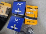 several different types of bicycle tires are sitting on the floor