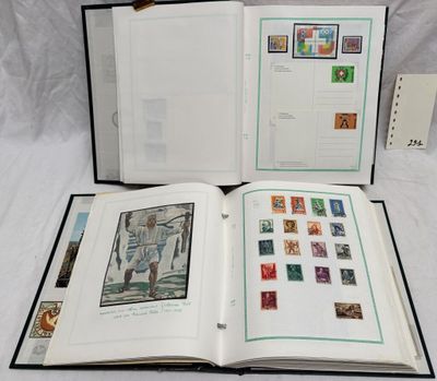 an open book with stamps on it sitting on a white surface