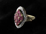 a close up of a pink stone ring on a black cloth