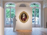 a painting of a man standing next to a painting of a woman in a red dress