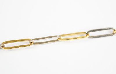 a gold and silver link bracelet on a white background