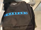 a black t - shirt with a blue line on it and a pair of brown shoes
