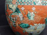 a vase with a painting on it on a black background
