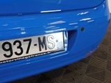 a close up of a blue car with a license plate on it